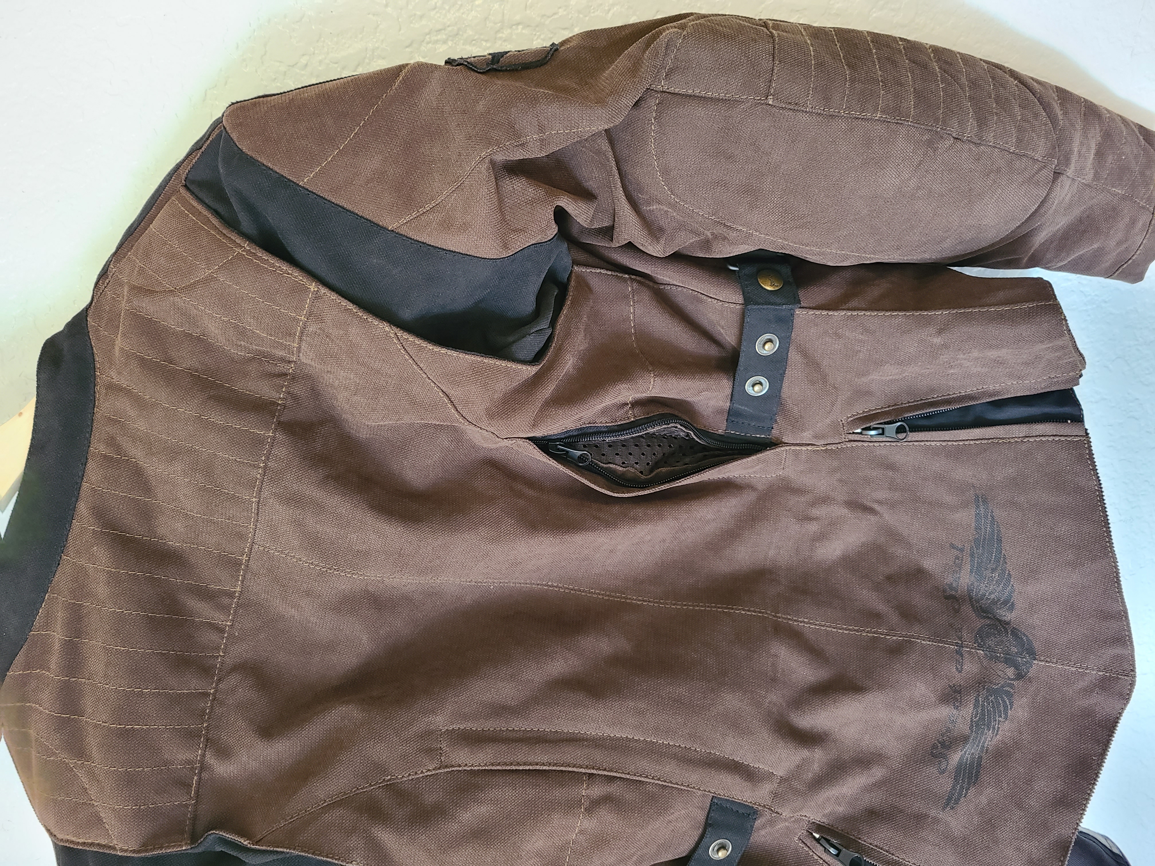 back of a brown jacket displaying different fit adjustments